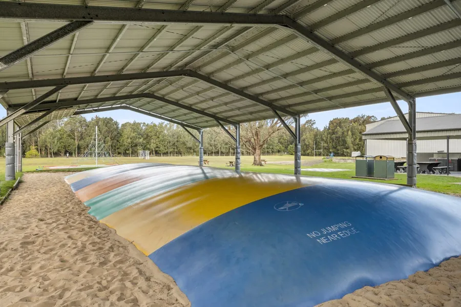 Children playing on the undercover jumping pillow