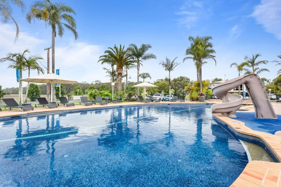 The solar-heated pool with its spiral slide and sun lounges