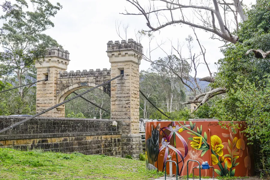 The castellated sandstone towers of Hampden Bridge among gum trees