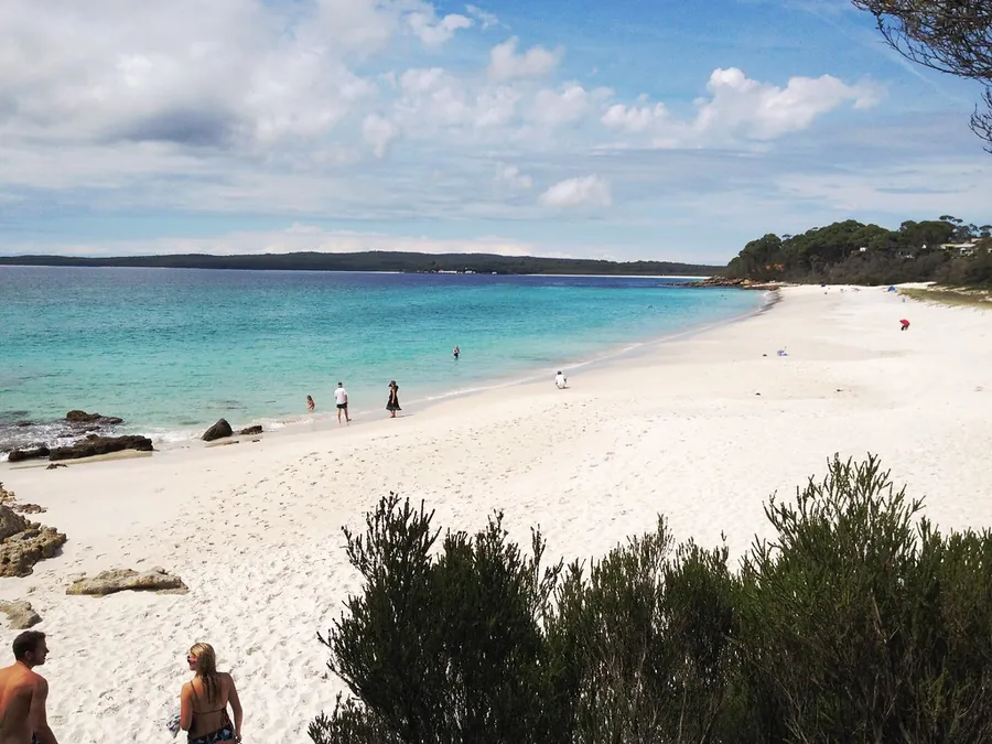 A curve of white sand and clear shallow water