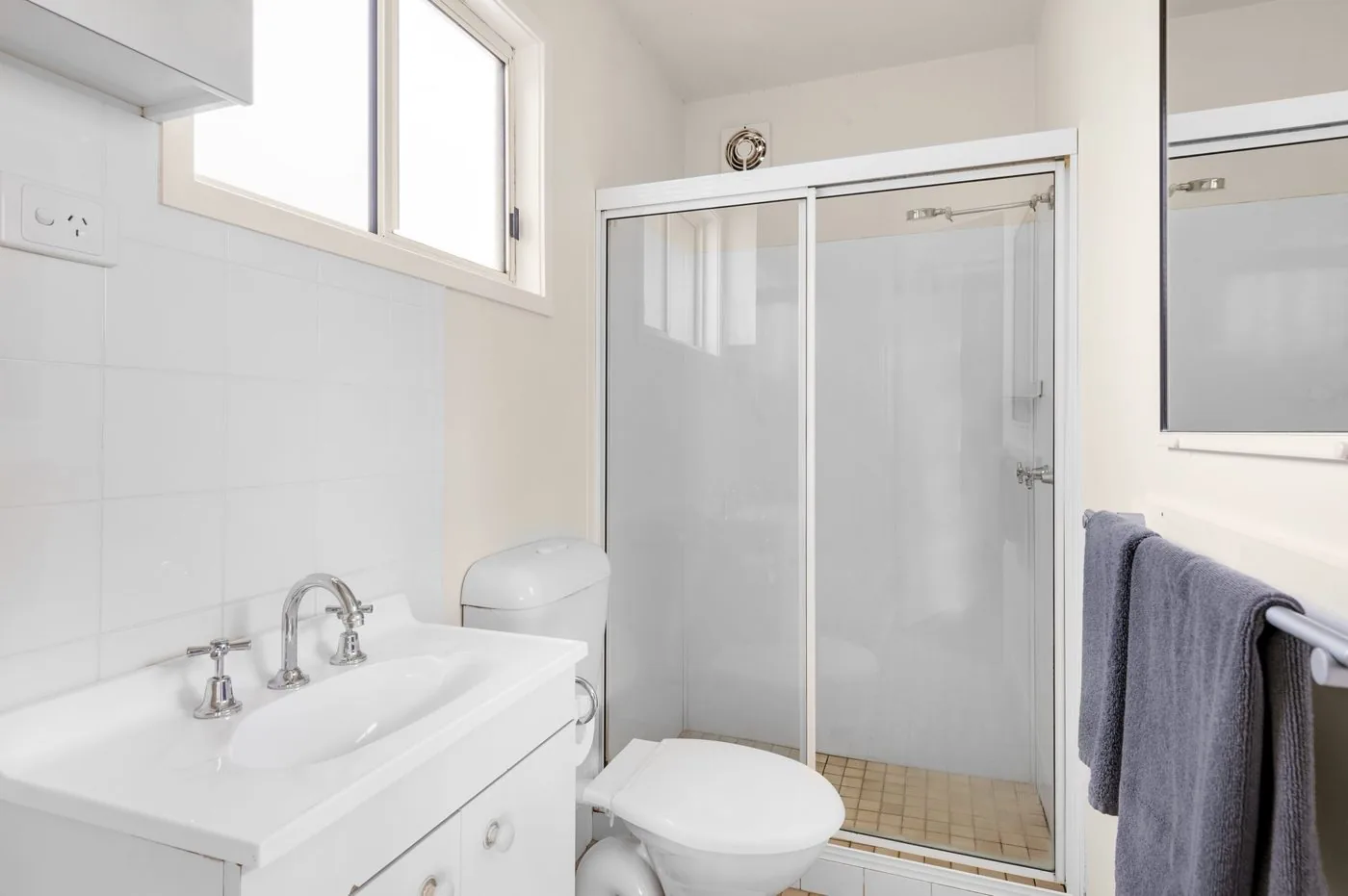 Bathroom with a vanity, toilet and a glass shower screen