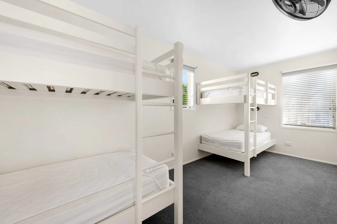 Second bedroom with a set of white bunks against the wall