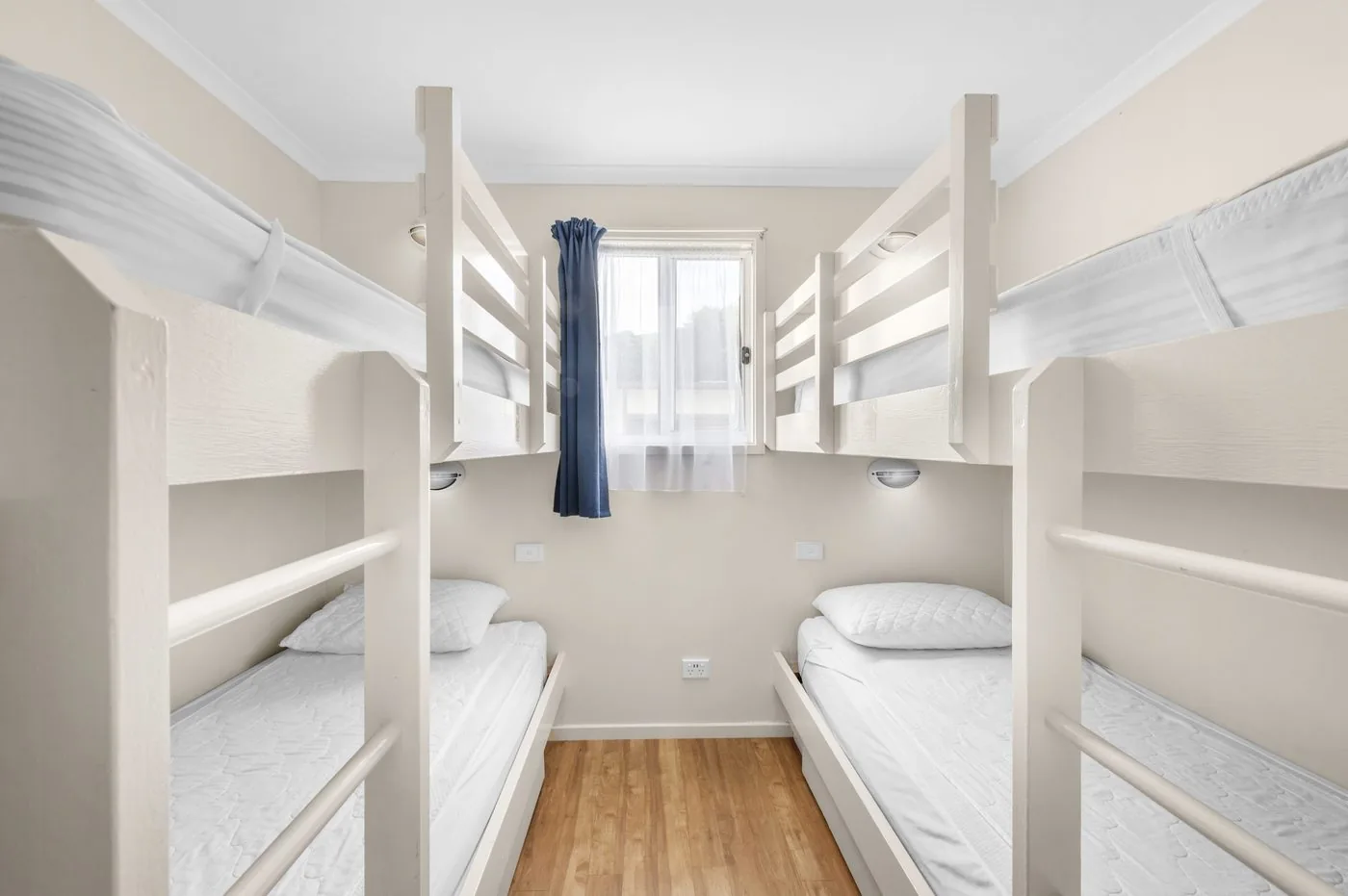 Bunk room with a pair of white bunks facing each other