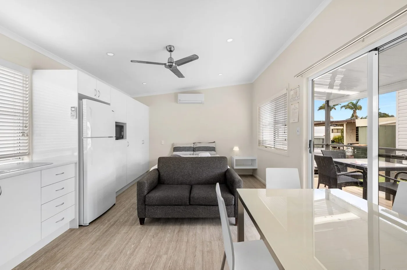 Sofa and dining setting beside a sliding door onto the veranda