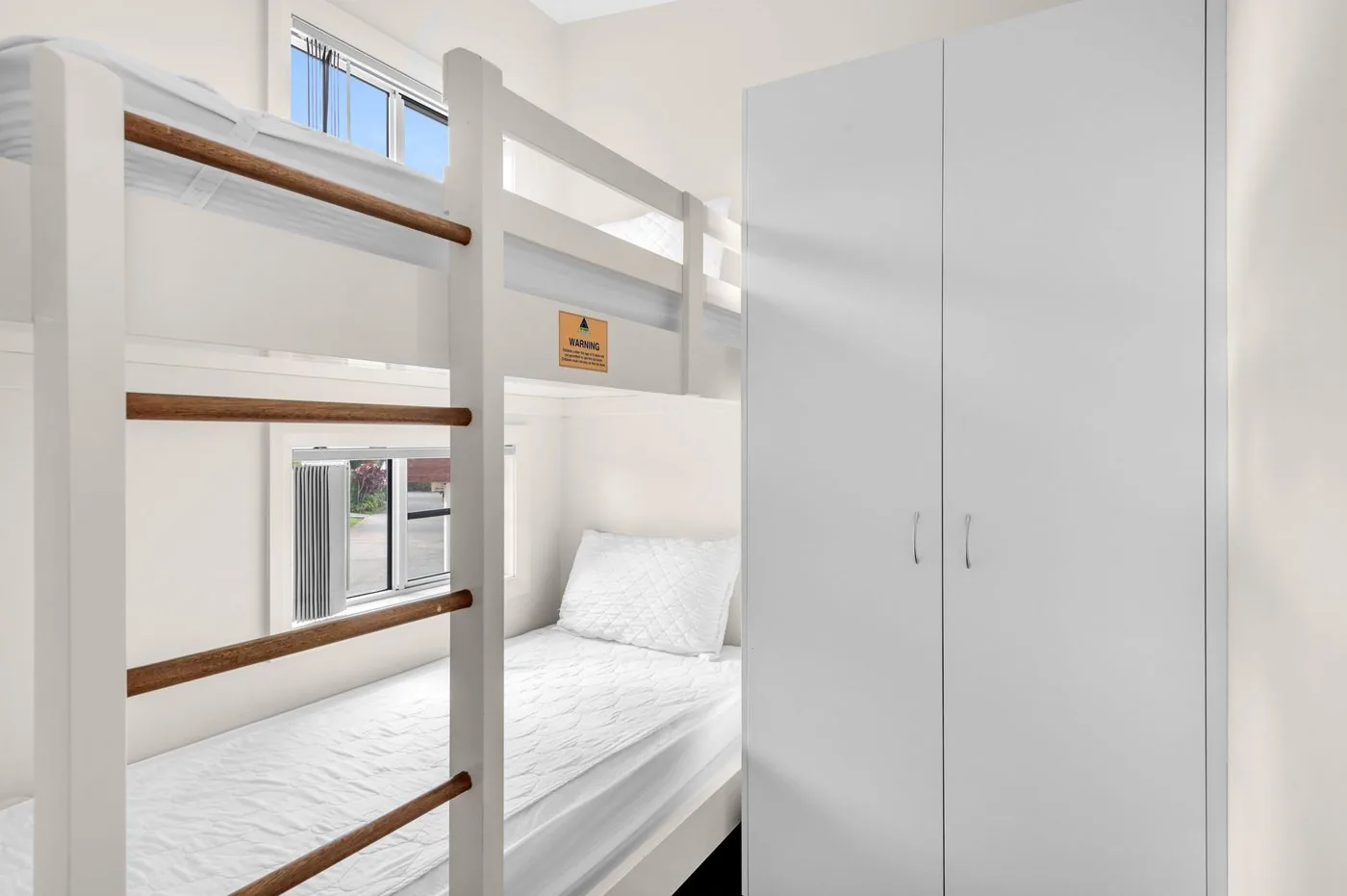 Timber bunk beds beside a built-in wardrobe