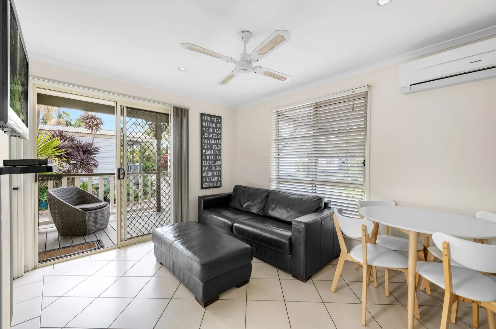 Living area with a sofa and sliding doors opening onto the veranda