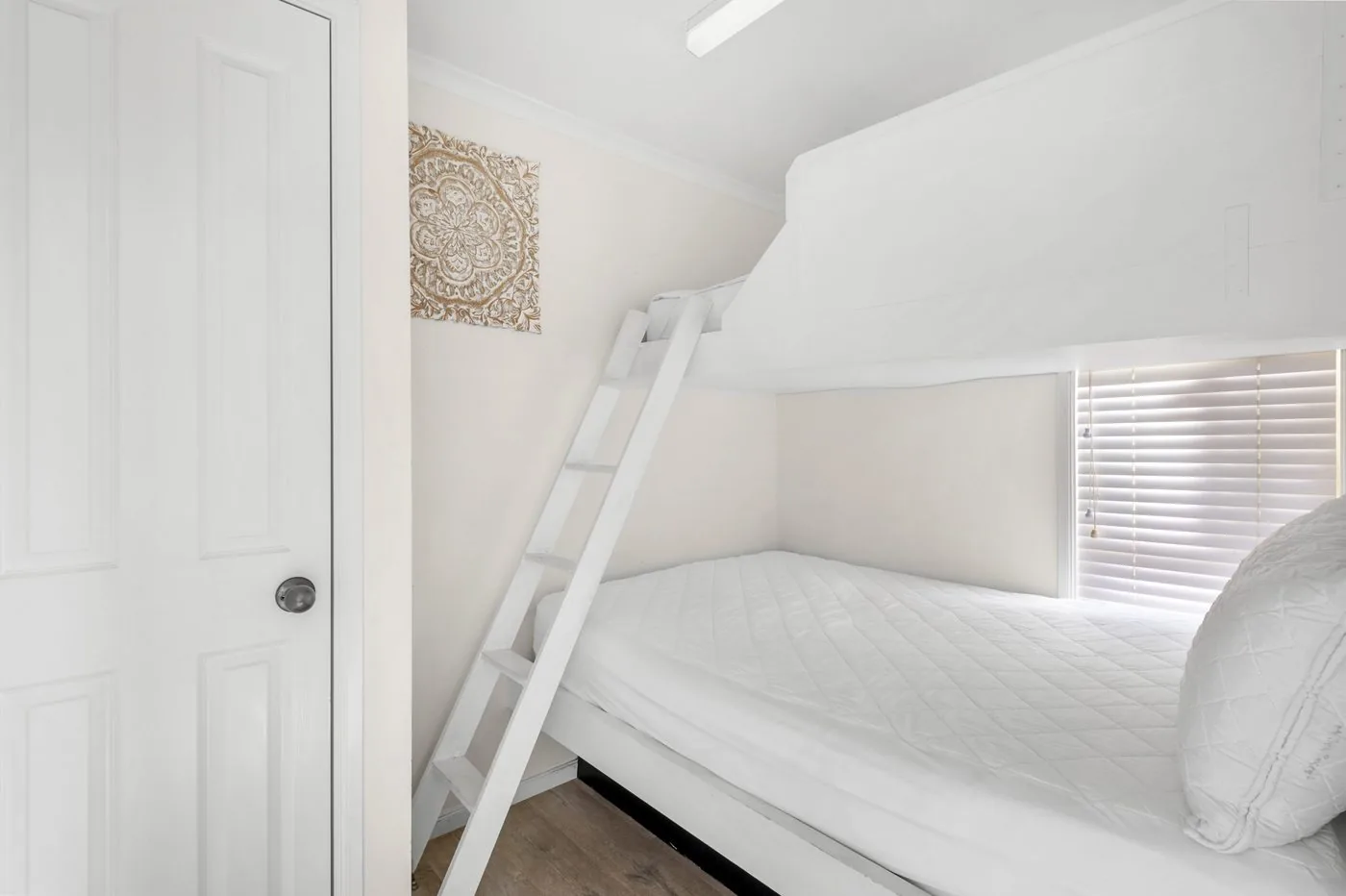 Second bedroom with a single bunk above a double bed and a ladder alongside