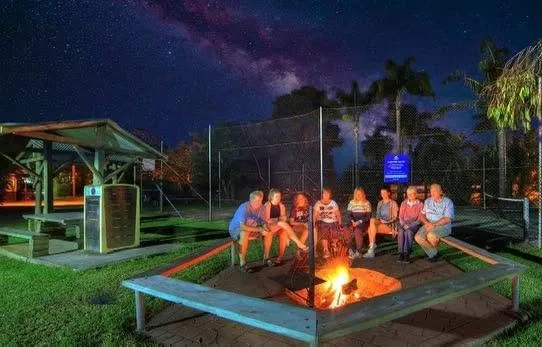 An evening campfire burning in the fire pit