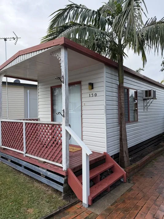 A one bedroom mobile home with a paved driveway